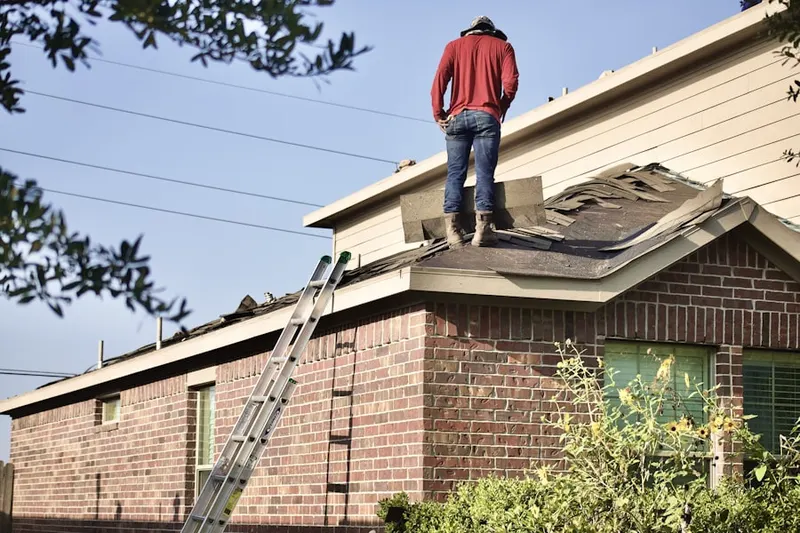 Professional roofer working on a residential roof in East Sacramento